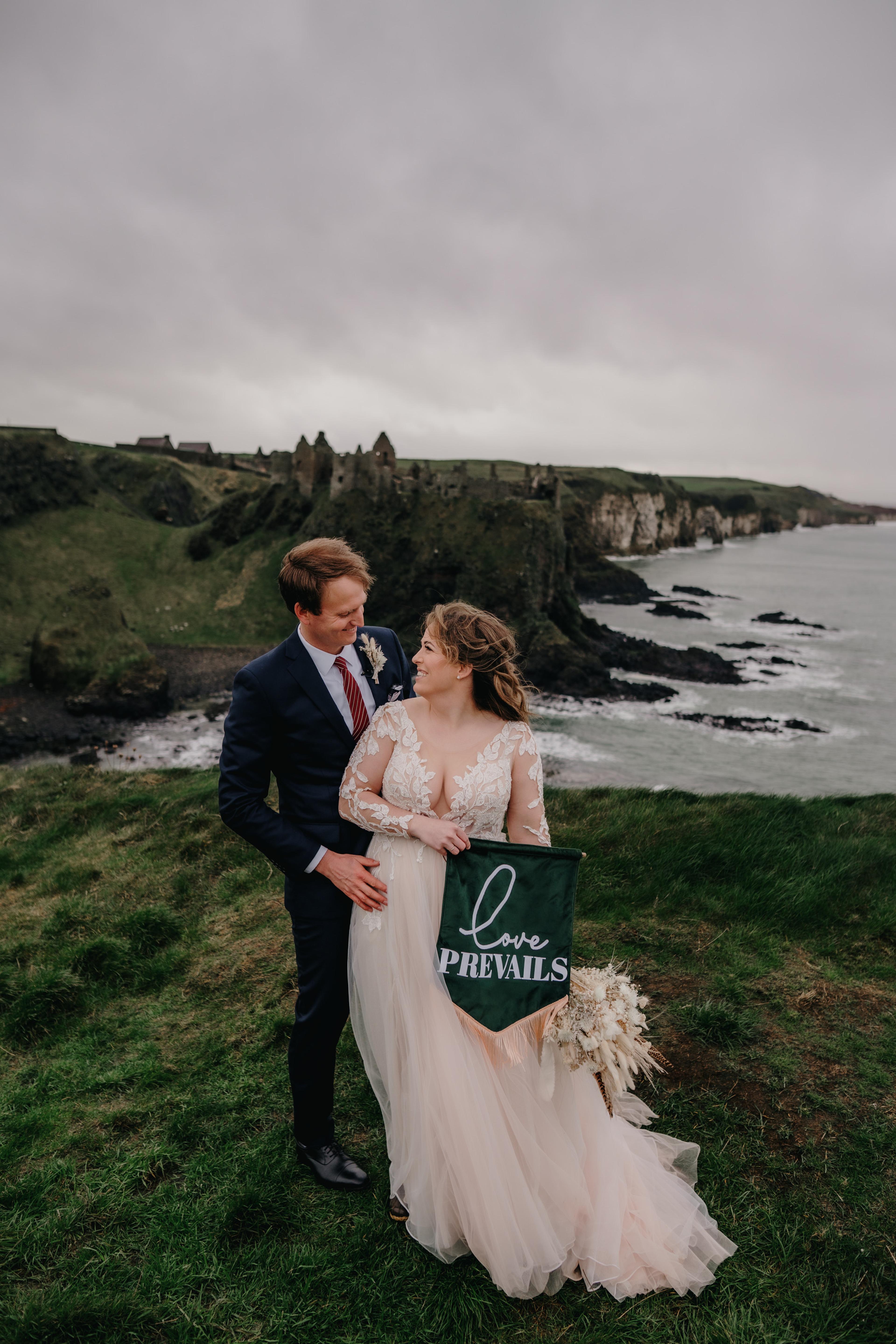 Couple holding Love prevails flag