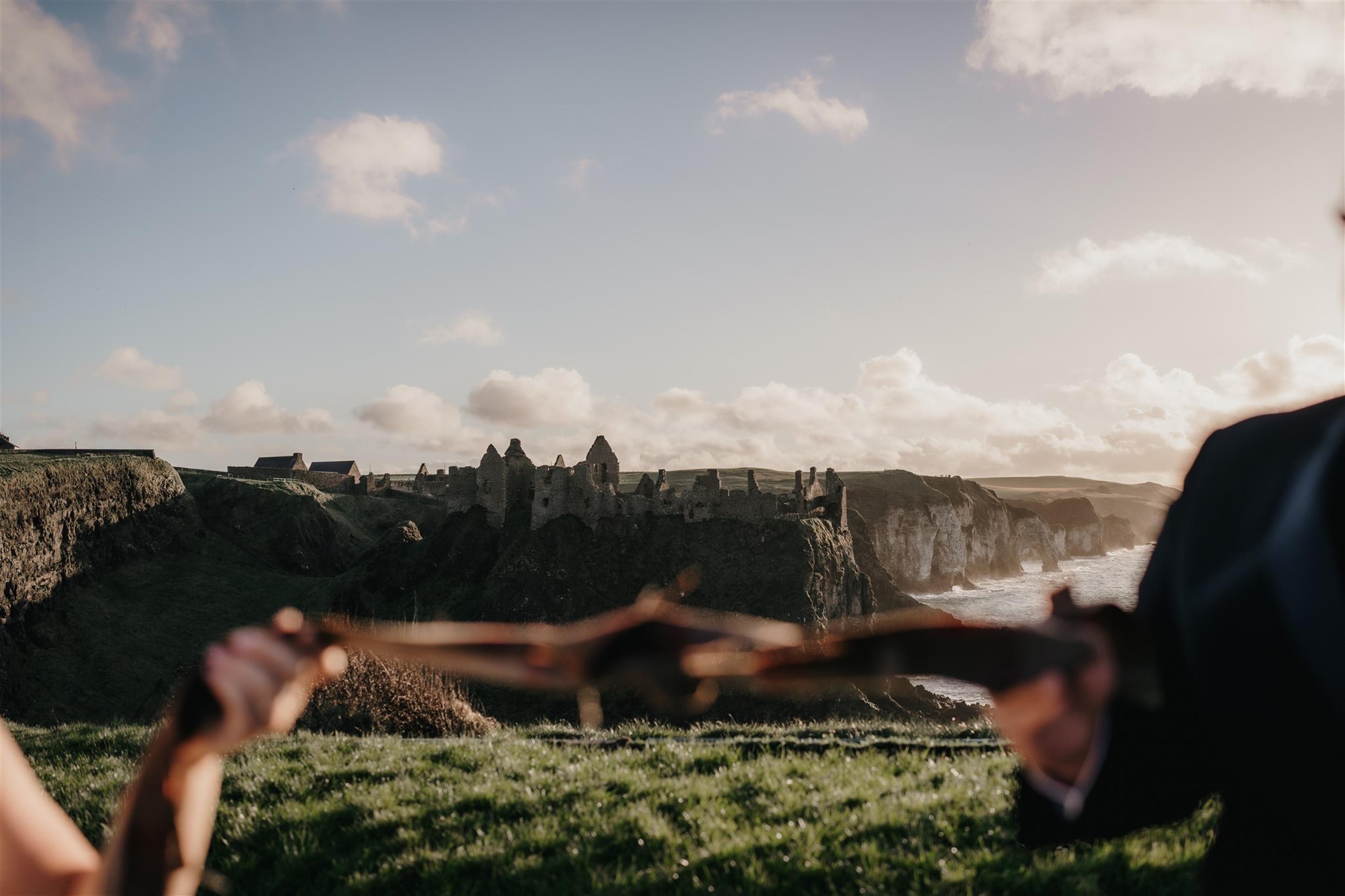 Newlywed couple holding ribbon